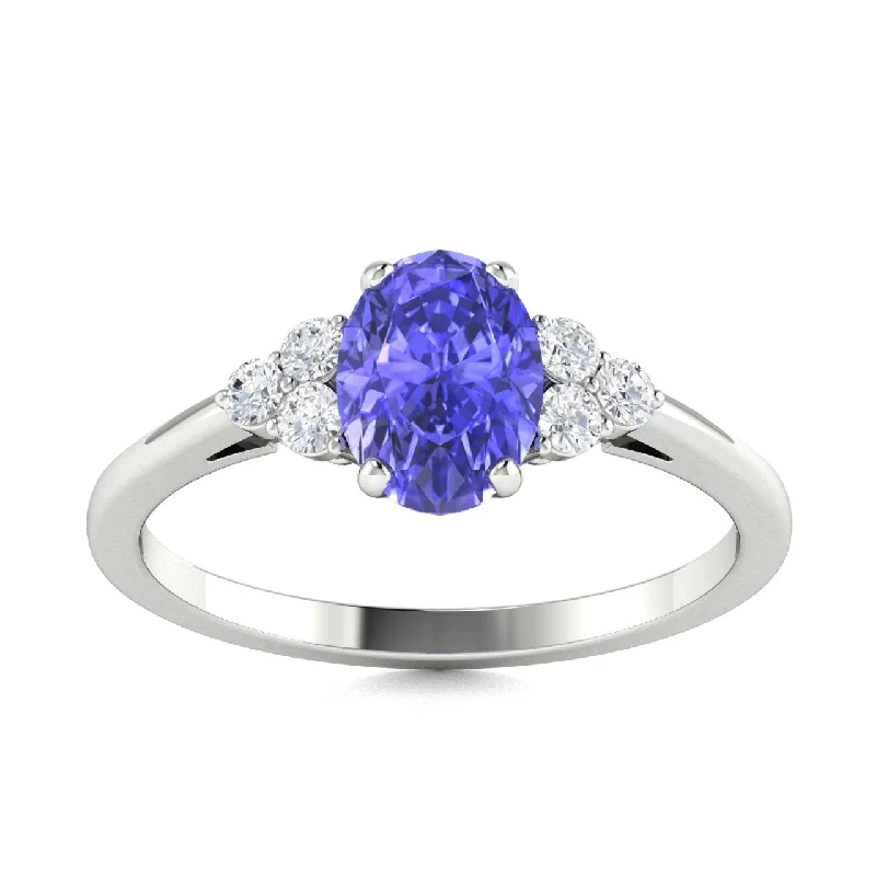 Unique engagement rings with halo diamonds around the center stone for radiance -18kt Gold Oval Shaped Tanzanite and Diamond Ring (Tanzanite 1.20ct Diamonds 0.10cts)