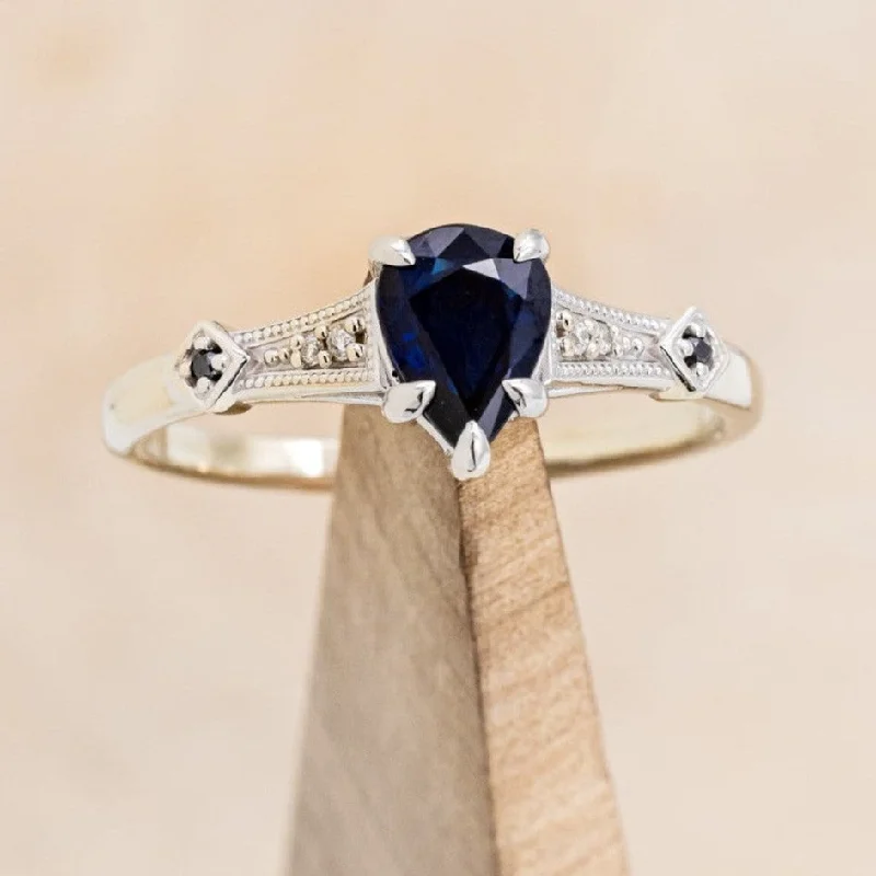 Two-tone engagement rings with contrasting metals for a chic, modern effect -"ANNORA" - PEAR SHAPED LAB-GROWN BLUE SAPPHIRE ENGAGEMENT RING WITH BLACK & WHITE DIAMOND ACCENTS