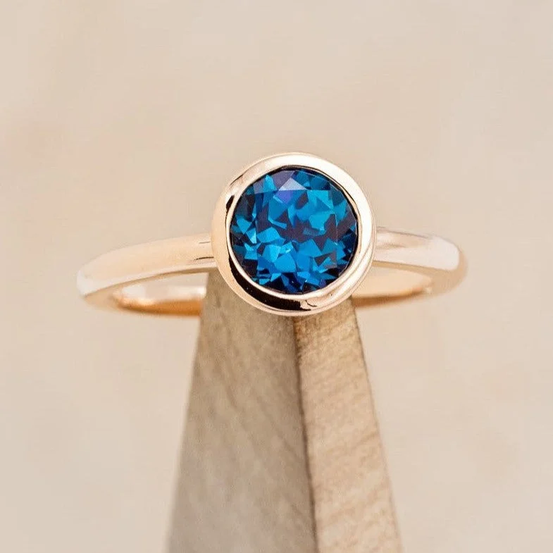 Unique engagement rings with halo diamonds around the center stone for radiance -ROUND CUT CYAN LAB-GROWN ALEXANDRITE SOLITAIRE ENGAGEMENT RING