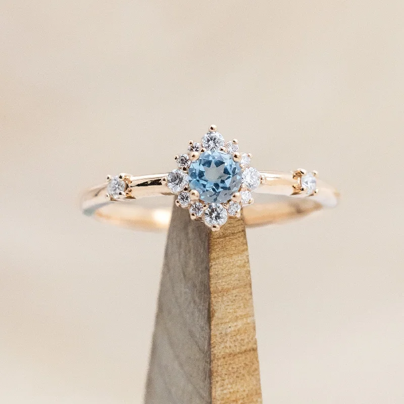 Affordable engagement rings with halo designs to maximize diamond sparkle and brilliance -"STARLA" - ROUND CUT BLUE TOPAZ ENGAGEMENT RING WITH STARBURST DIAMOND HALO