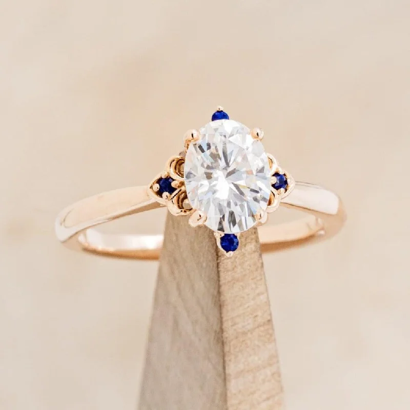 Elegant solitaire engagement rings with sleek bands for understated beauty and grace -"ZELLA" - OVAL CUT MOISSANITE ENGAGEMENT RING WITH GENUINE BLUE SAPPHIRE ACCENTS